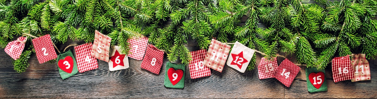 KI generiert: Ein Adventskalender mit nummerierten Säckchen hängt vor Tannenzweigen.